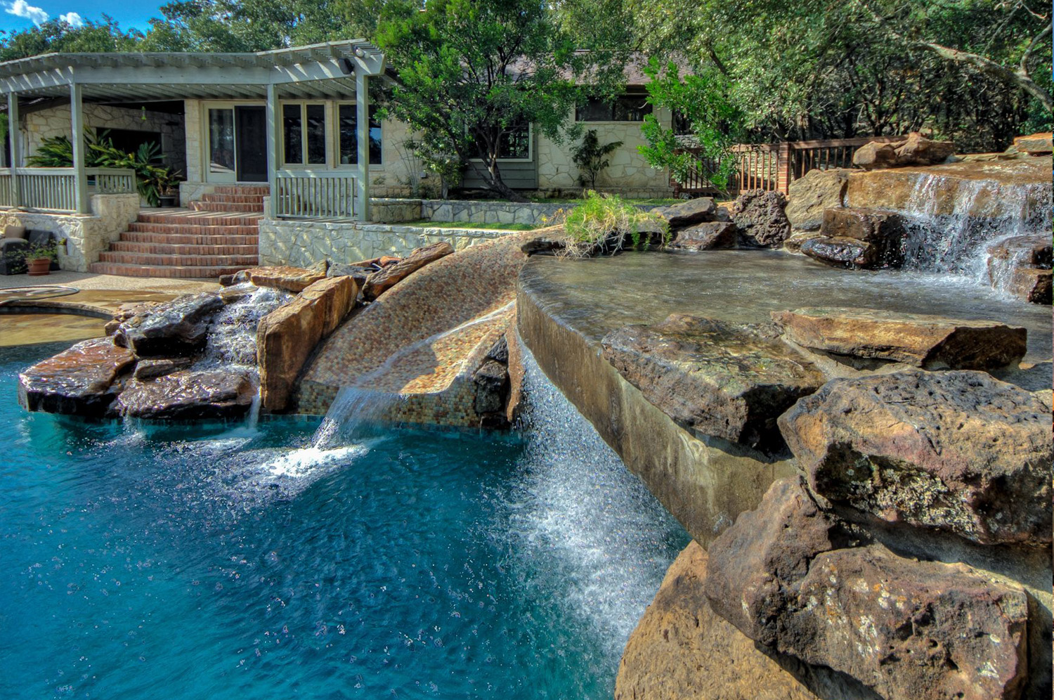 Pool remodel with rock waterfall feature.