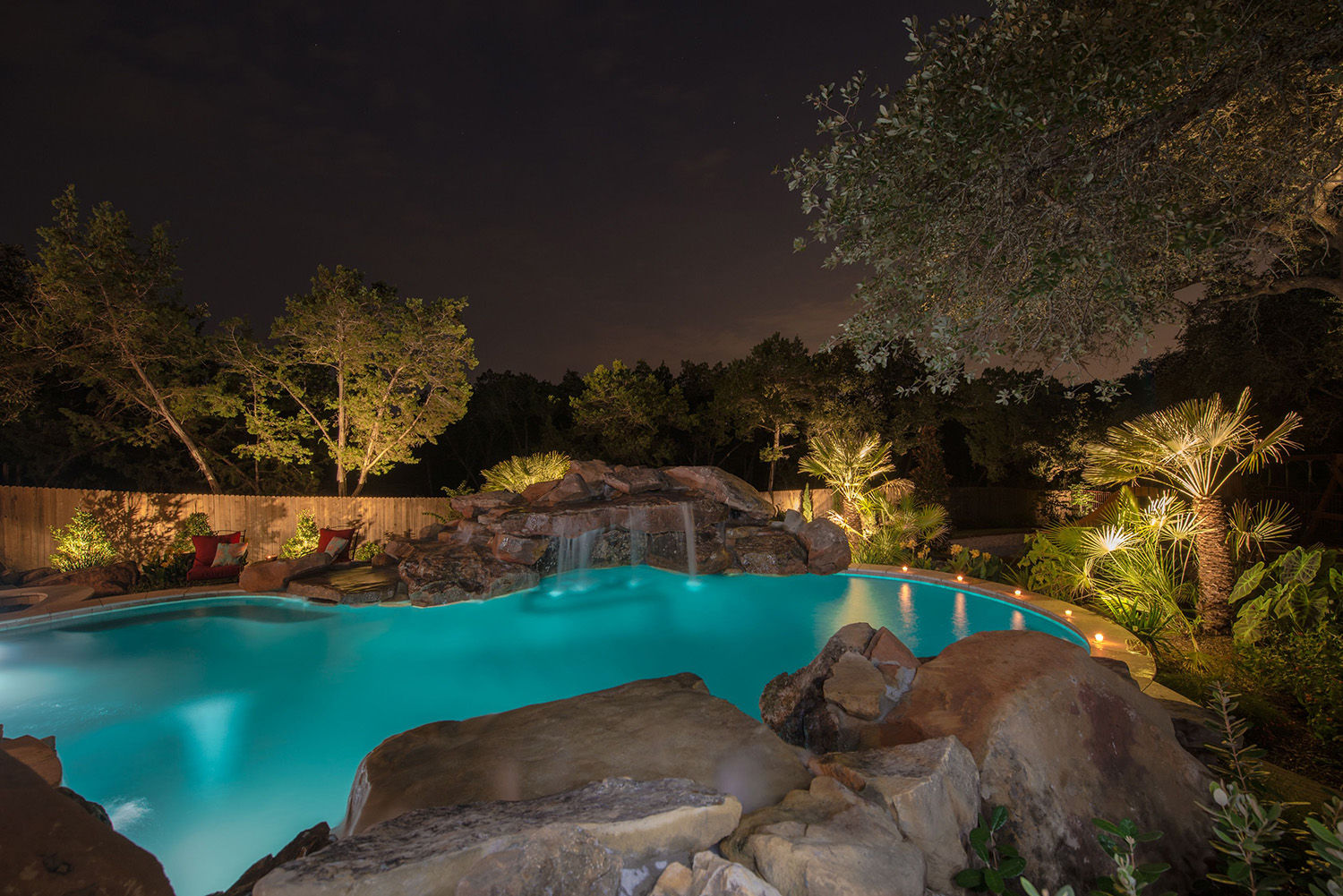 Automated technology and LED lighting make this custom pool stunning at night.