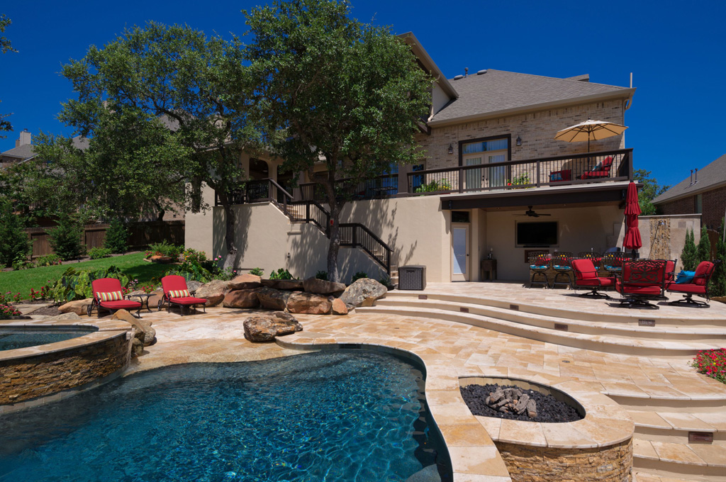 Contemporary pool with many water features.