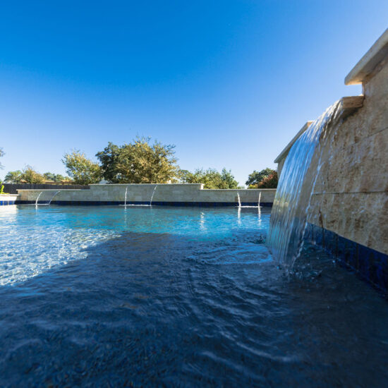 Waterfall features in this San Antonio pool create a calm and relaxing environment.
