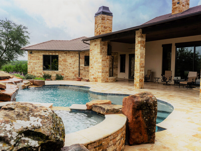 Travertine Beach Entry in this freeform pool design.