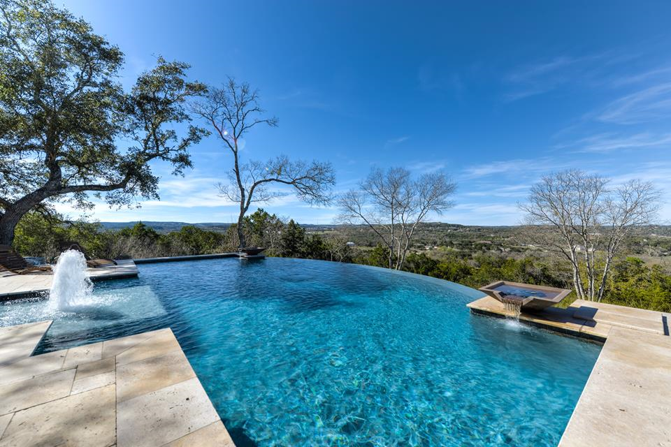 Modern pool with infinity edge design and beautiful water features.