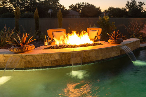 A poolscape with fire pit pool feature